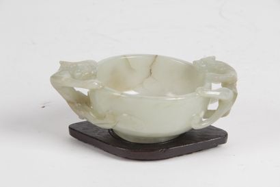 null CHINA, 19th CENTURY Small celadon jade bowl with rust veining, the handles formed...