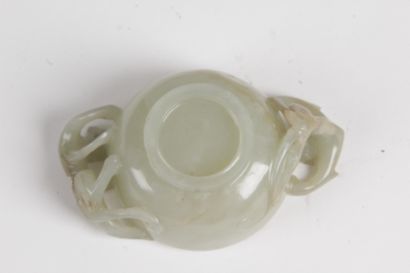 null CHINA, 19th CENTURY Small celadon jade bowl with rust veining, the handles formed...