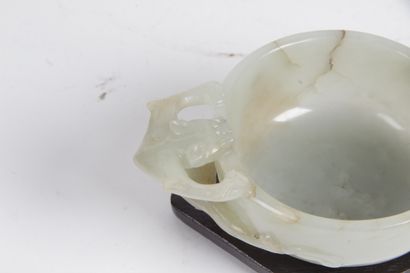 null CHINA, 19th CENTURY Small celadon jade bowl with rust veining, the handles formed...