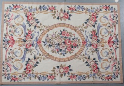 null MAION ROMÉO. small points carpet on beige background decorated with flowers...