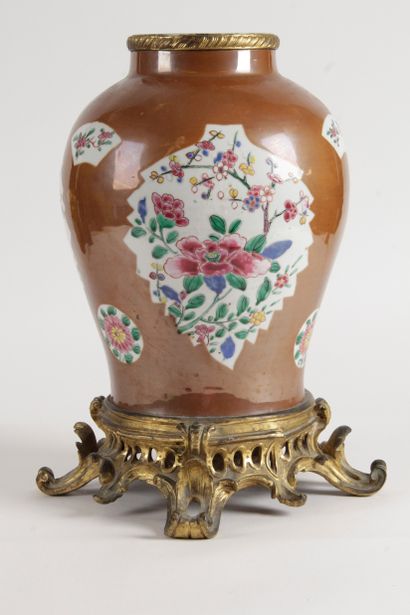 null China, 18th century Porcelain and enamel vase of the pink family on a café au...