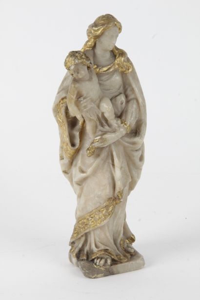 null Standing virgin carrying Christ on her right side, alabaster group with gilding...