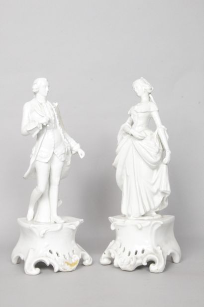 null Pair of white porcelain FIGURINES showing a couple in the 18th century style...