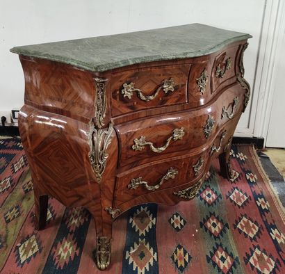 null A veneer and marquetry chest of drawers opening in front with five drawers on...