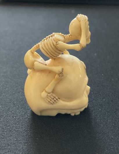 null JAPON, XIXe siècle Netsuke en ivoire* sculpté à motif d’un squelette à califourchon...