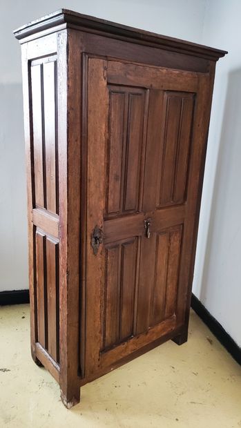 null A WARDROBE opening with one door, decorated with raised panels, wrought iron...