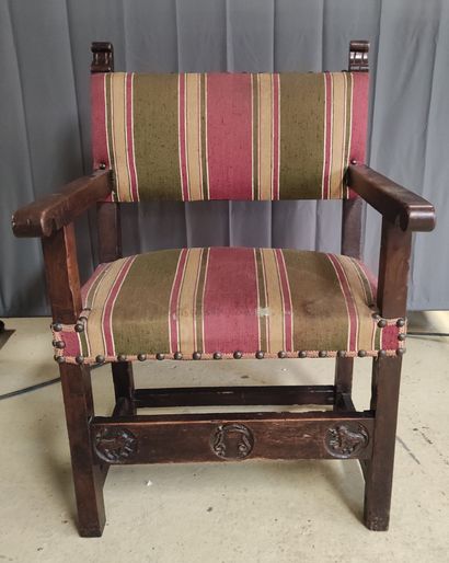 Walnut armchair with a front band carved...
