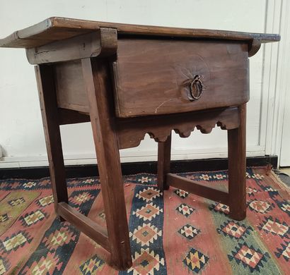 A patinated poplar table with a drawer and...