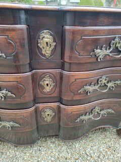 null A moulded and carved oak COMMODE with a crossbow front and moving sides opening...