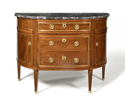 null A mahogany half-moon chest of drawers with three drawers in the front and two...