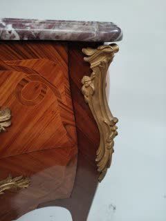 null A veneer and marquetry chest of drawers opening on the front with two drawers...