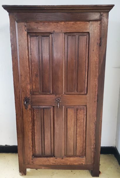 null A WARDROBE opening with one door, decorated with raised panels, wrought iron...