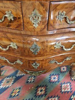 null A veneer and marquetry chest of drawers opening in front with five drawers on...