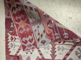 null KILIM with geometric patterns in predominantly red, white, grey and yellow....