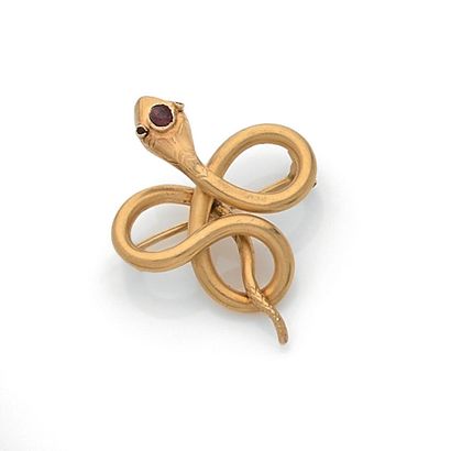 null A brooch with a design of a coiled snake with a ruby on the head. Set in 18K...