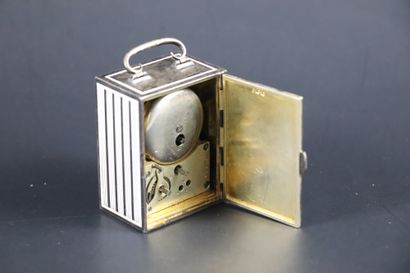 null CLOCK AROUND 1900. N°91919. Small silver and white enamel desk clock with alarm...
