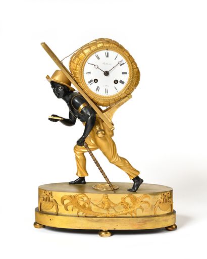 null A patinated and gilt bronze "portefaix" clock representing a Nubian bust and...