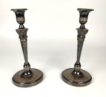 null PAIR OF silver FLAMPS the round base decorated with laurel leaves, monogrammed...