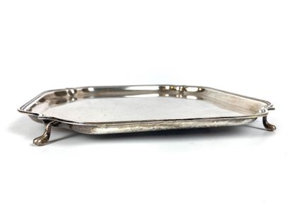null A silver plate with threaded edges, the contours with inward angles and resting...