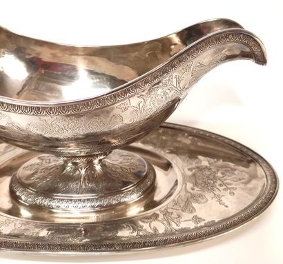 null A silver HELMET SAUCIERE on its frame, richly chased and engraved with foliage,...