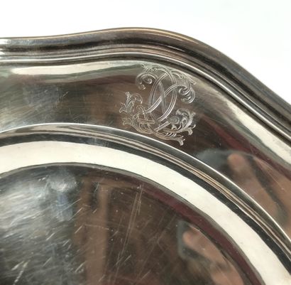 null A silver round dish with a filleted outline, the edge chased with initials....