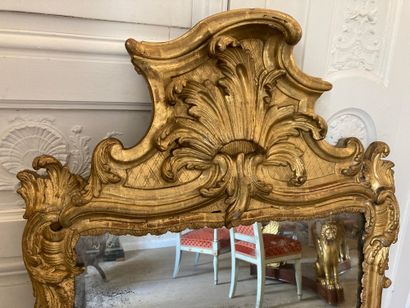 null Large gilded wood MIRROR with foliage decoration, the pediment decorated with...