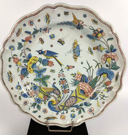 null FOUR glazed polychrome earthenware PLATES decorated with floral bouquets and...