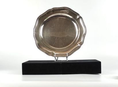 null A silver round dish with a filleted outline, the edge chased with initials....