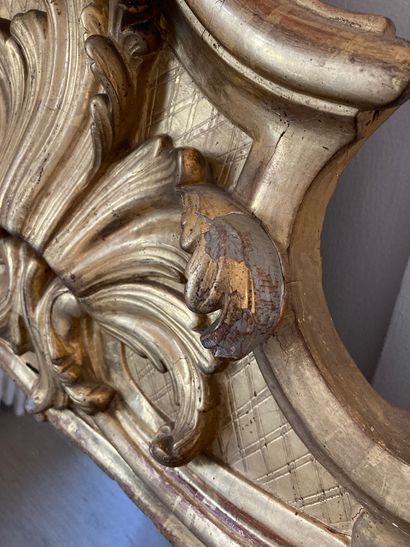 null Large gilded wood MIRROR with foliage decoration, the pediment decorated with...
