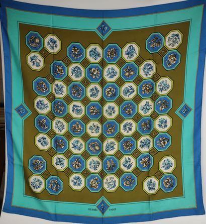 HERMES Turquoise and blue silk scarf on a...