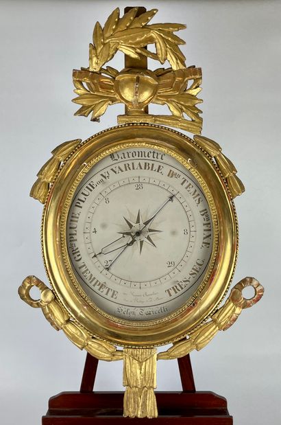 null Gilded wood BAROMETER with circular view and decoration on the pediment of a...