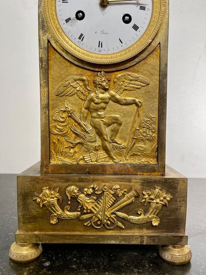 null A gilt bronze and chased clock decorated with a love on the damping. The circular...