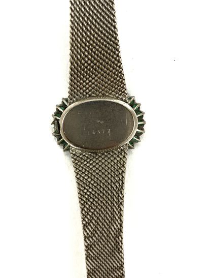 null WATCH with an oval dial in a double circle of brilliant-cut diamonds and emeralds....
