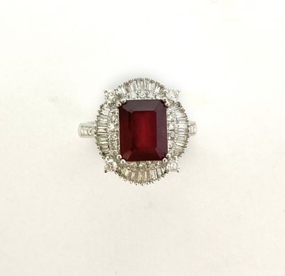 null RING holding an oval tray holding a rectangular cut ruby of about 3.30 carats...