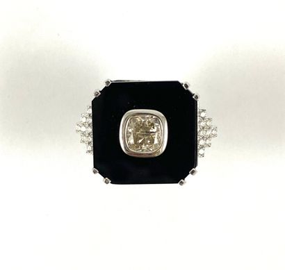 null Octagonal ring holding a 1.19 carat old cut cushion diamond on an onyx plate...