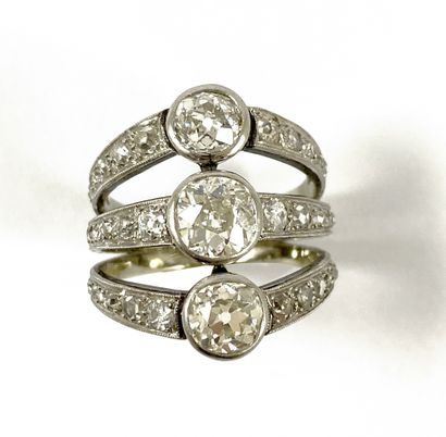null RING holding three lines of old-cut diamonds in a closed setting, set with a...