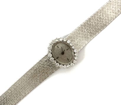 null WATCH adorned with an oval dial, baton hour markers, textured silver background....