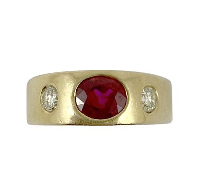 null RING holding an oval ruby of about 0.60 carat, with two brilliant-cut diamonds....