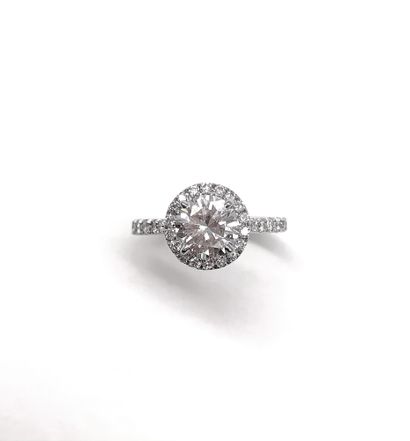 RING holding a 1.26 carat brilliant-cut diamond...