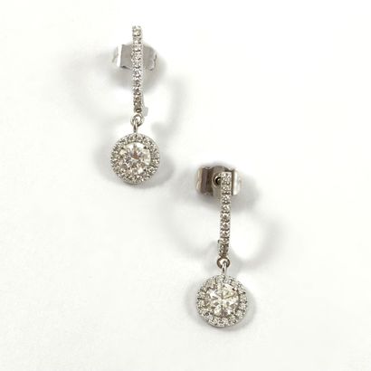 null PAIR OF EARRINGS adorned with a line of brilliant-cut diamonds holding a tassel...