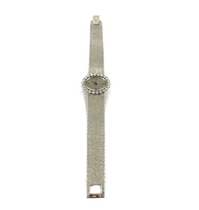 null WATCH adorned with an oval dial, baton hour markers, textured silver background....