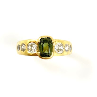 null RING holding a 1.5 carat cushion green sapphire set with old cut diamonds. Mounted...