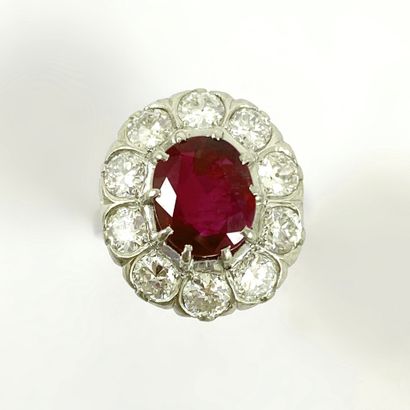 null RING (UNCHALLED BIRMAN RUBY) holding a 3.06 carat ruby in a setting of old cut...