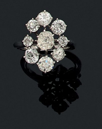 null RING holding a flower design adorned in its center with an old cut cushion diamond...