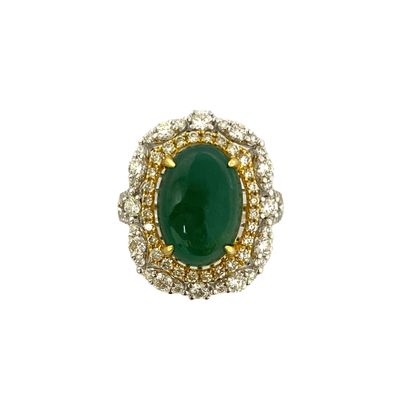 null RING holding a cabochon emerald of 5.70 carats in a double surround of brilliant-cut...