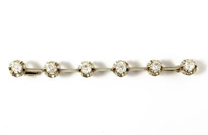 null A brooch holding a series of six old cut diamonds. Mounting in 18K white gold....