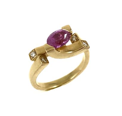 RING holding an oval pink sapphire with four...