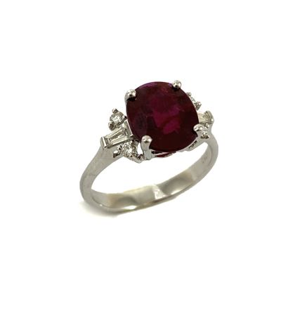 null RING holding an oval ruby of 2.35 carats with six tapers and brilliant cut diamonds....