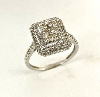 RING holding a rectangular design paved with...