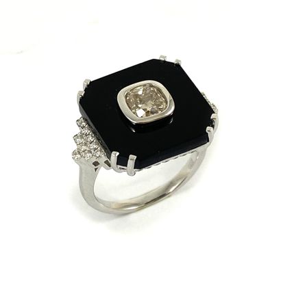 null Octagonal ring holding a 1.19 carat old cut cushion diamond on an onyx plate...